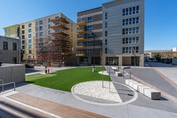 A modern courtyard surrounded by multi-story buildings.